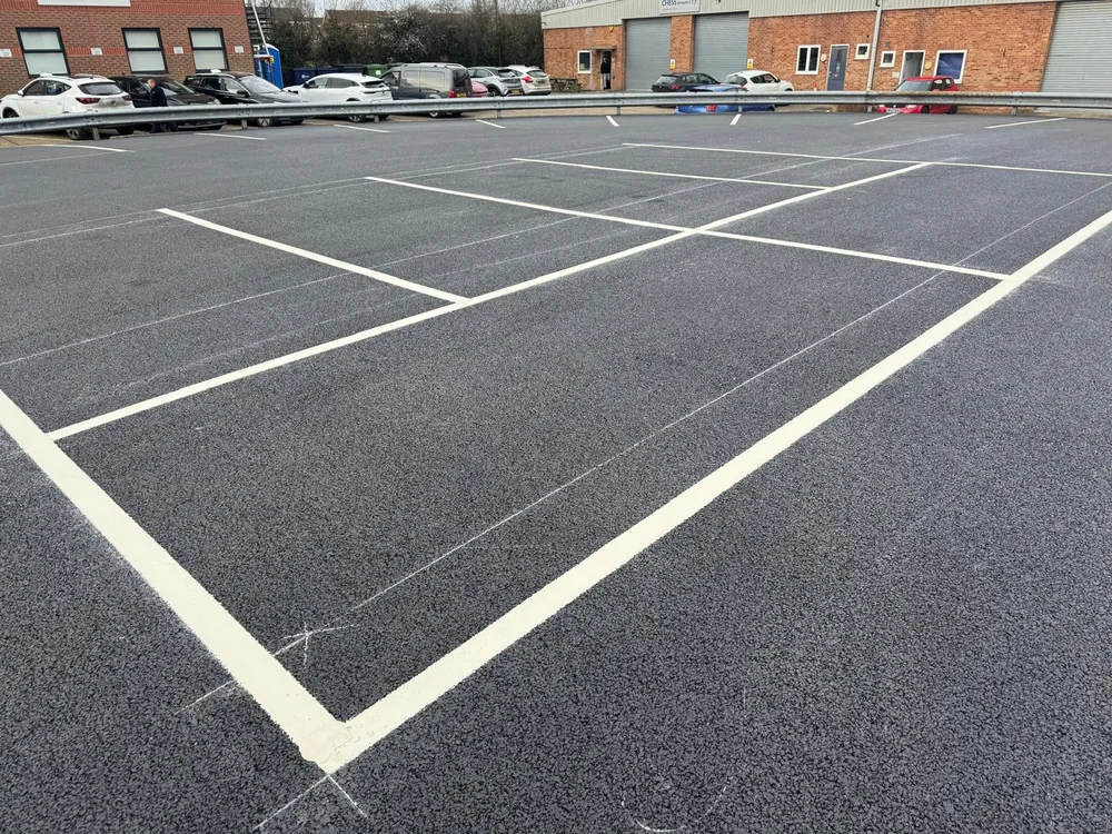 Fresh parking bay markings on a resurfaced car park